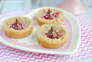 Peanut Butter Cup Cookies for Valentine's Day - These peanut butter cookie cups are soft and chewy. The peanut butter cookie with kisses makes it easy to add the Valentine touch! It's a great twist on your classic peanut butter cookie!