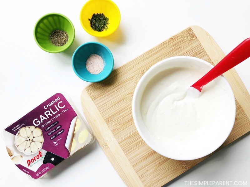 Season your creamy garlic dipping sauce with salt and pepper.