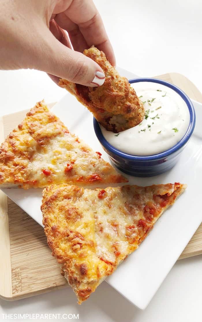 Dipping pizza crust in the easy garlic sauce.
