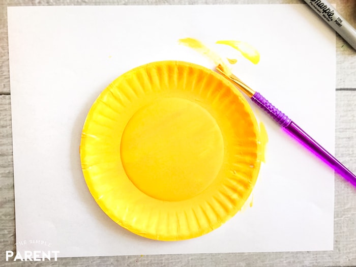 Paint a paper plate yellow to make a puffer fish craft