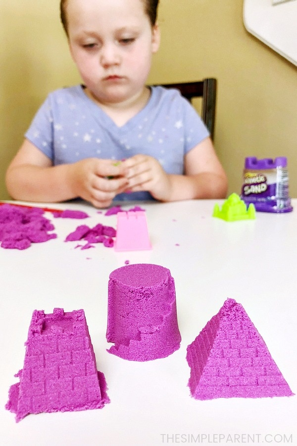 Girl playing with Kinetic Sand from Spin Master