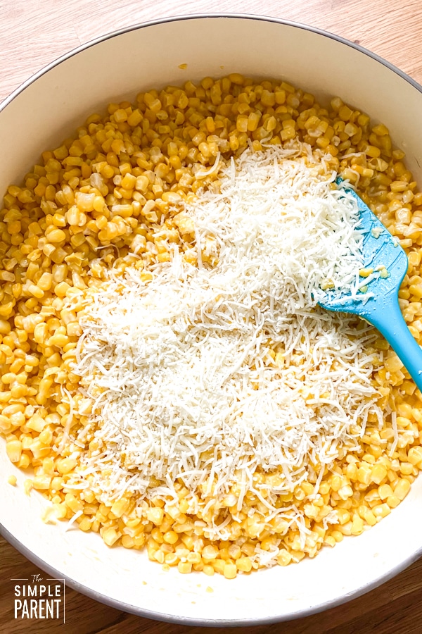 Corn and shredded cheese in a pan