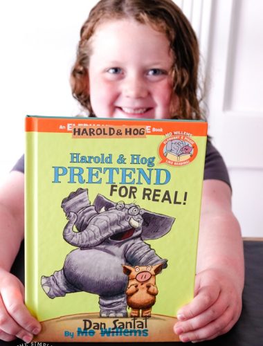Girl holding Harold and Hog Pretend for Real! book