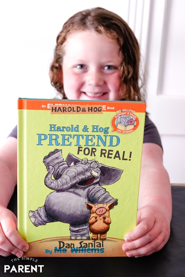 Girl holding Harold and Hog Pretend for Real! book