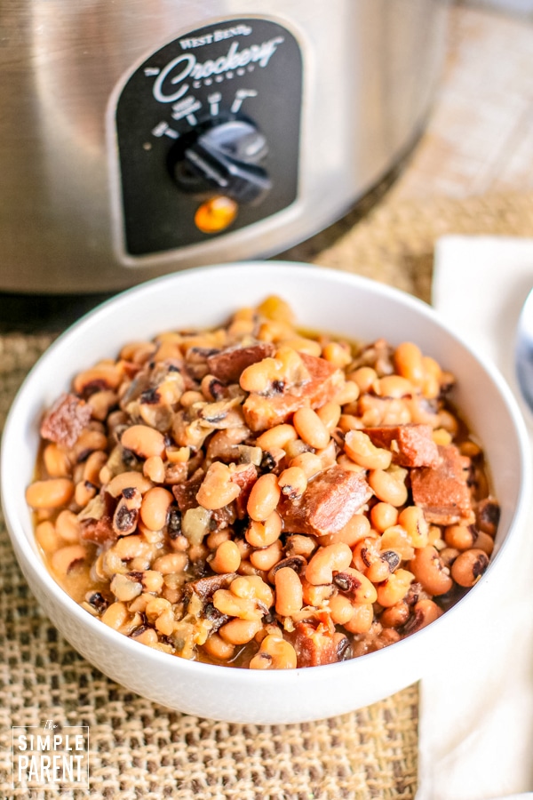 Bowl of black-eyed peas in front of a slow cooker
