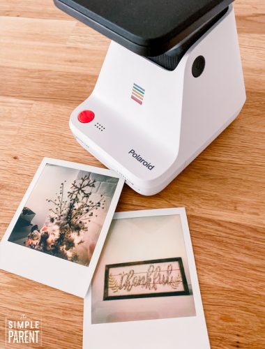 Polaroid photos sitting next to a Polaroid Lab printer