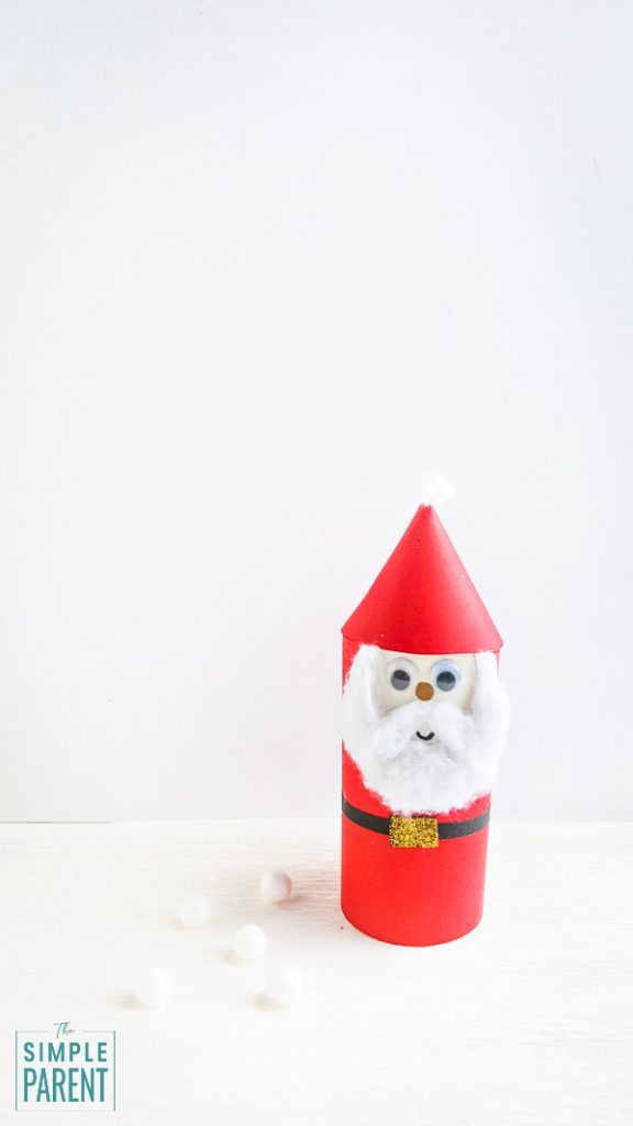 Finished paper Santa Claus craft in front of a white wall