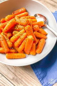 Bowl of oven roasted baby carrots with honey and garlic butter glaze