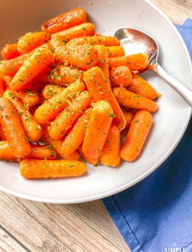 Bowl of oven roasted baby carrots with honey and garlic butter glaze