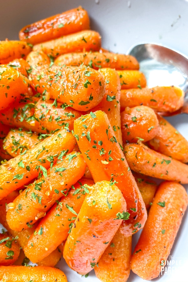 Bowl of cooked honey carrots with parsley