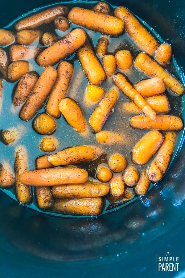 Cooking glazed carrots in a black Crockpot