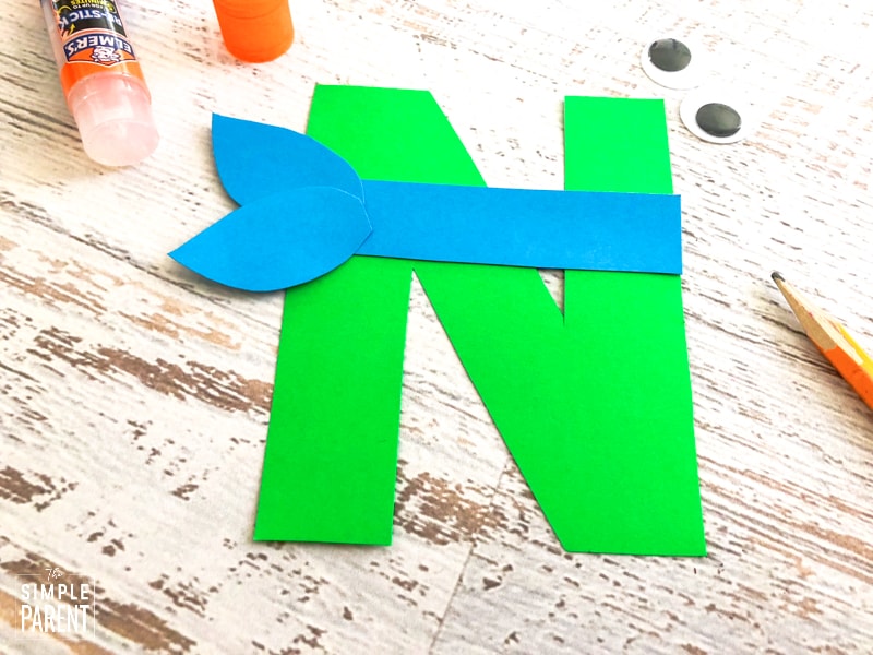 Green letter N with blue bandana shape