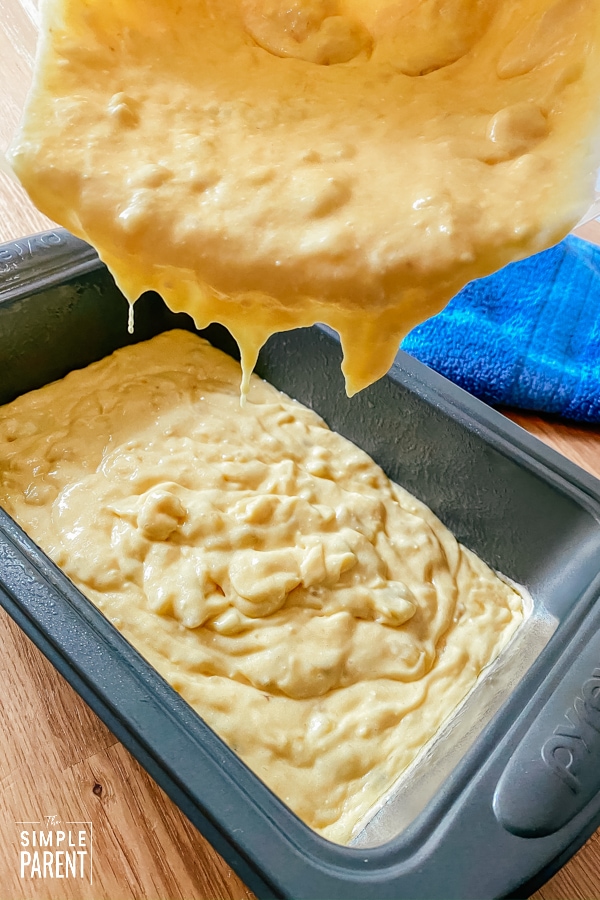 Pouring banana bread batter into loaf pan