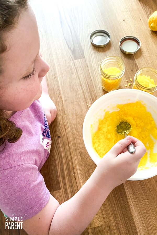 Girl making jars of lemon sugar scrub