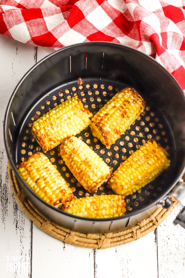 Corn in air fryer basket on counter