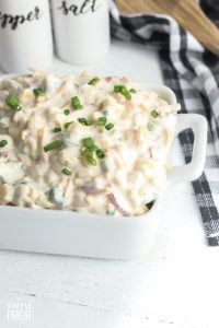 Creamy corn salad recipe in a white serving bowl
