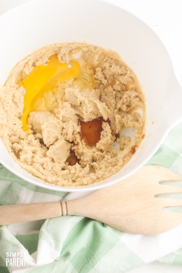 Brown sugar mixture and egg in a white mixing bowl