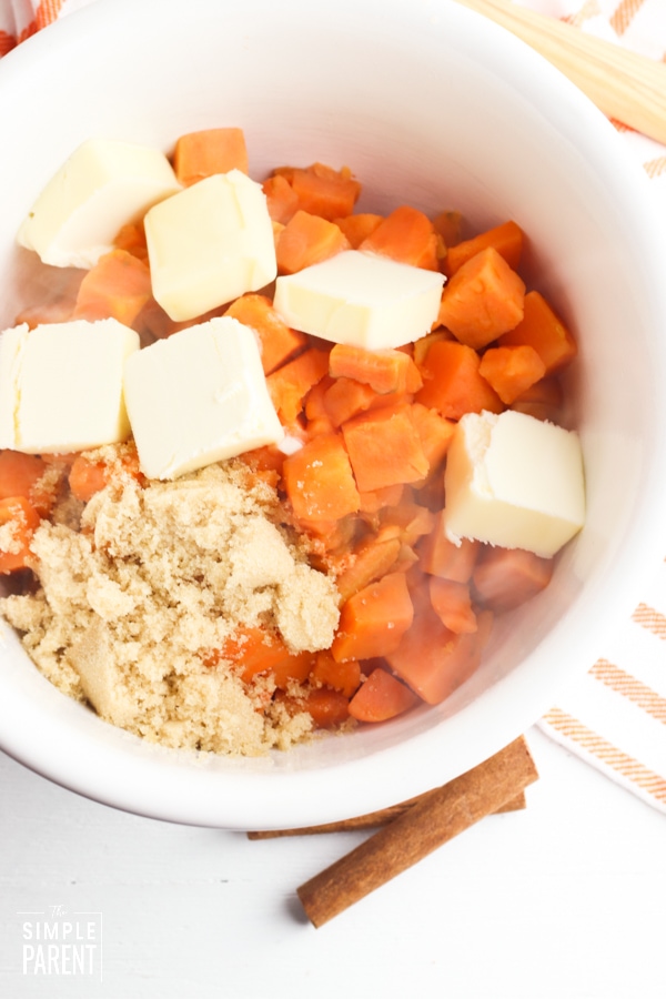 Sweet potatoes, butter, and brown sugar in a mixing bowl