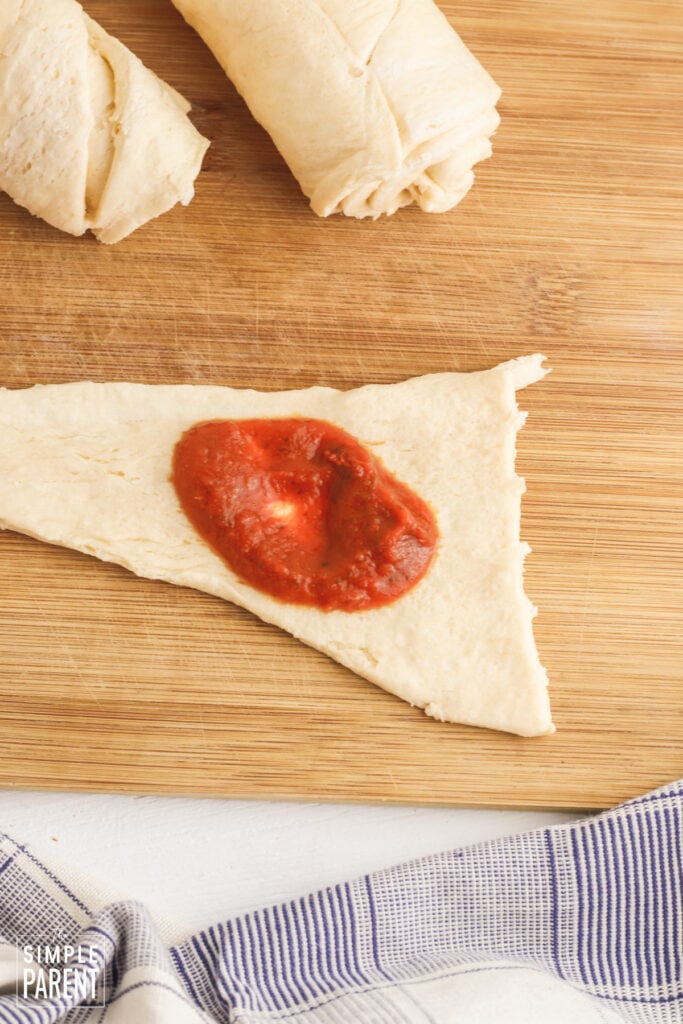 Crescent dough triangles with pizza sauce in the middle