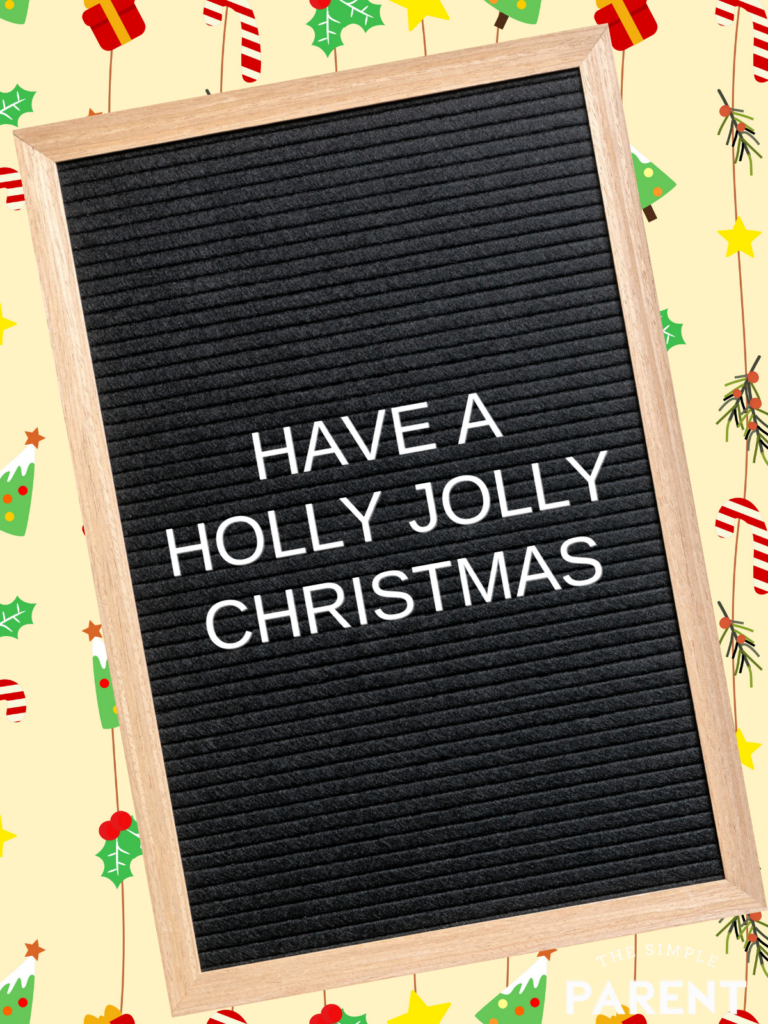 Black letterboard with wood frame with Christmas saying "Have a Holly Jolly Christmas" in white letters