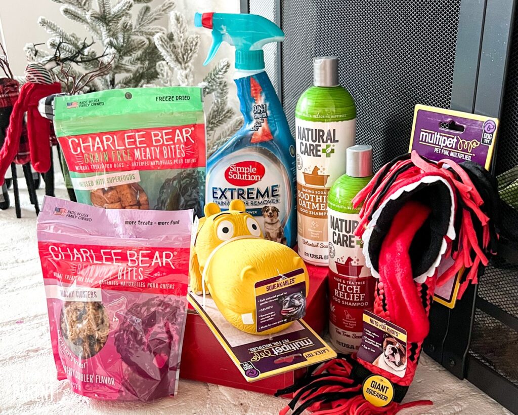 Gift Ideas for Pets on a fire place dog treats, dog toys, shampoo and cleaning spray