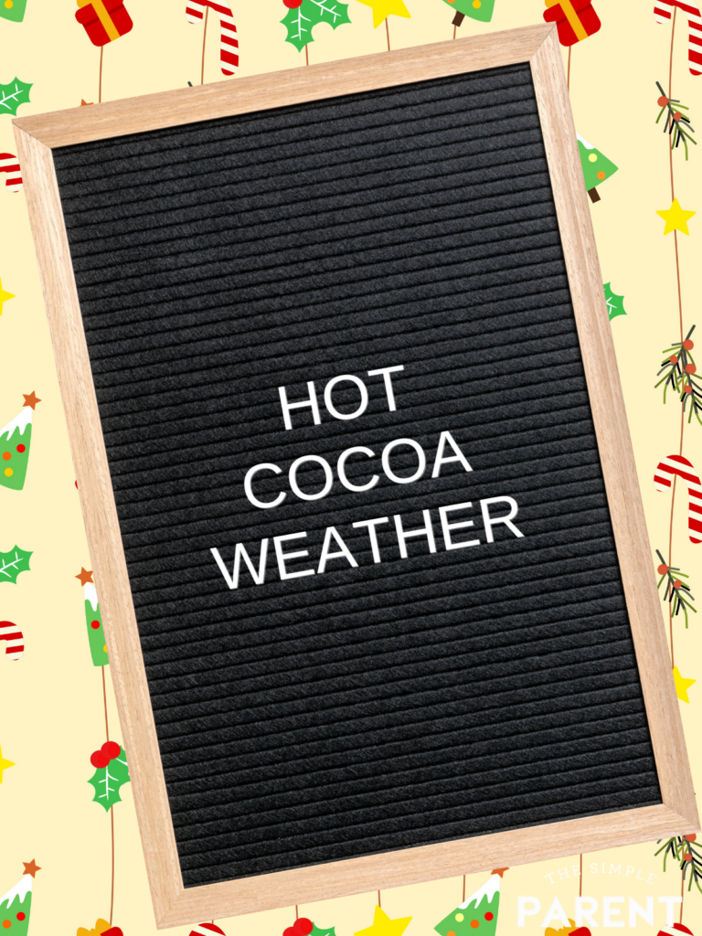 Black letterboard with wood frame and winter saying "Hot Cocoa Weather" in white letters