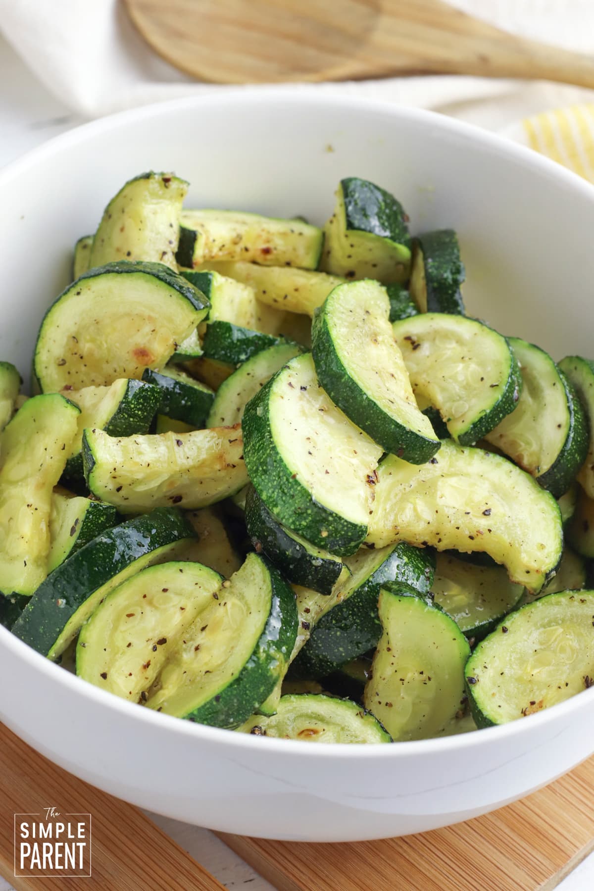 Air fryer roasted zucchini slices in white serving bowl