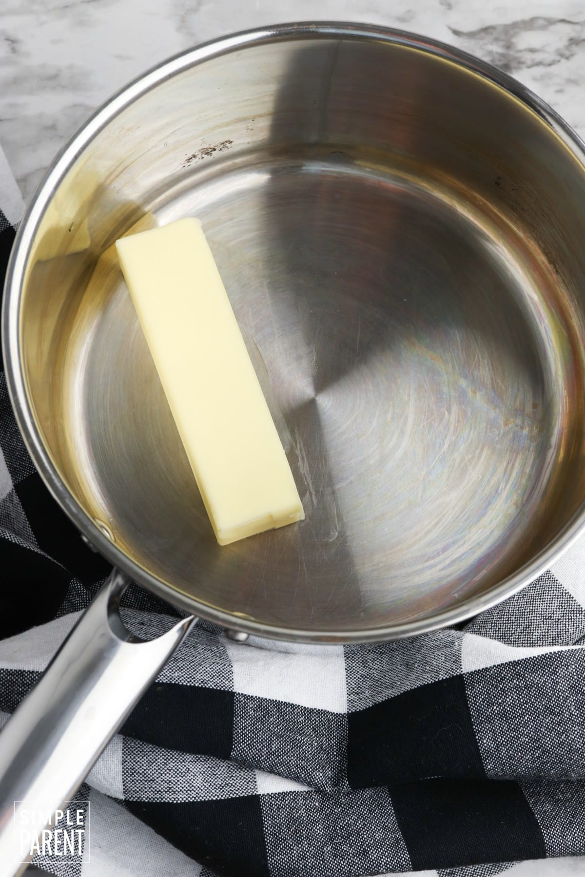 Stick of butter in metal cooking pot
