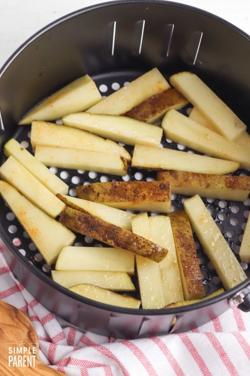 Seasoned potato wedges in air fryer  basket