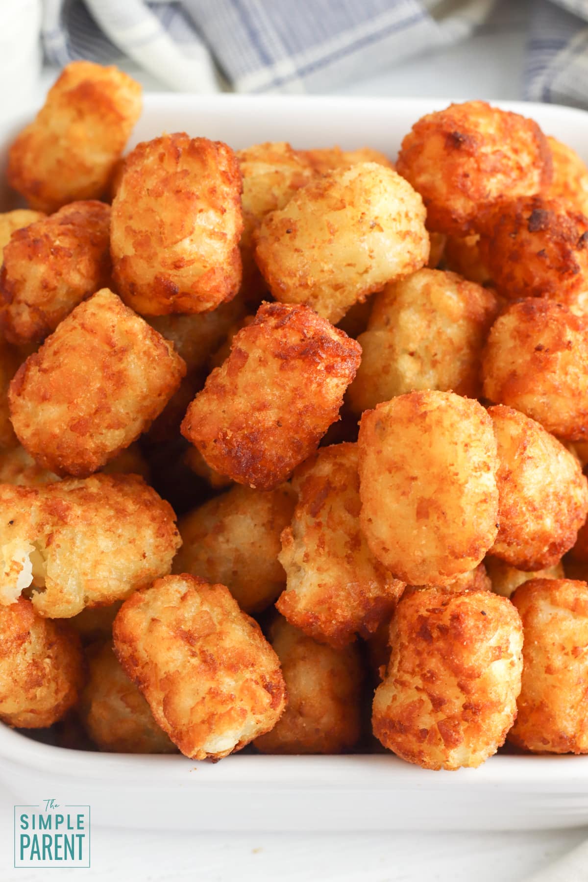 Cooked frozen tater tots in white bowl