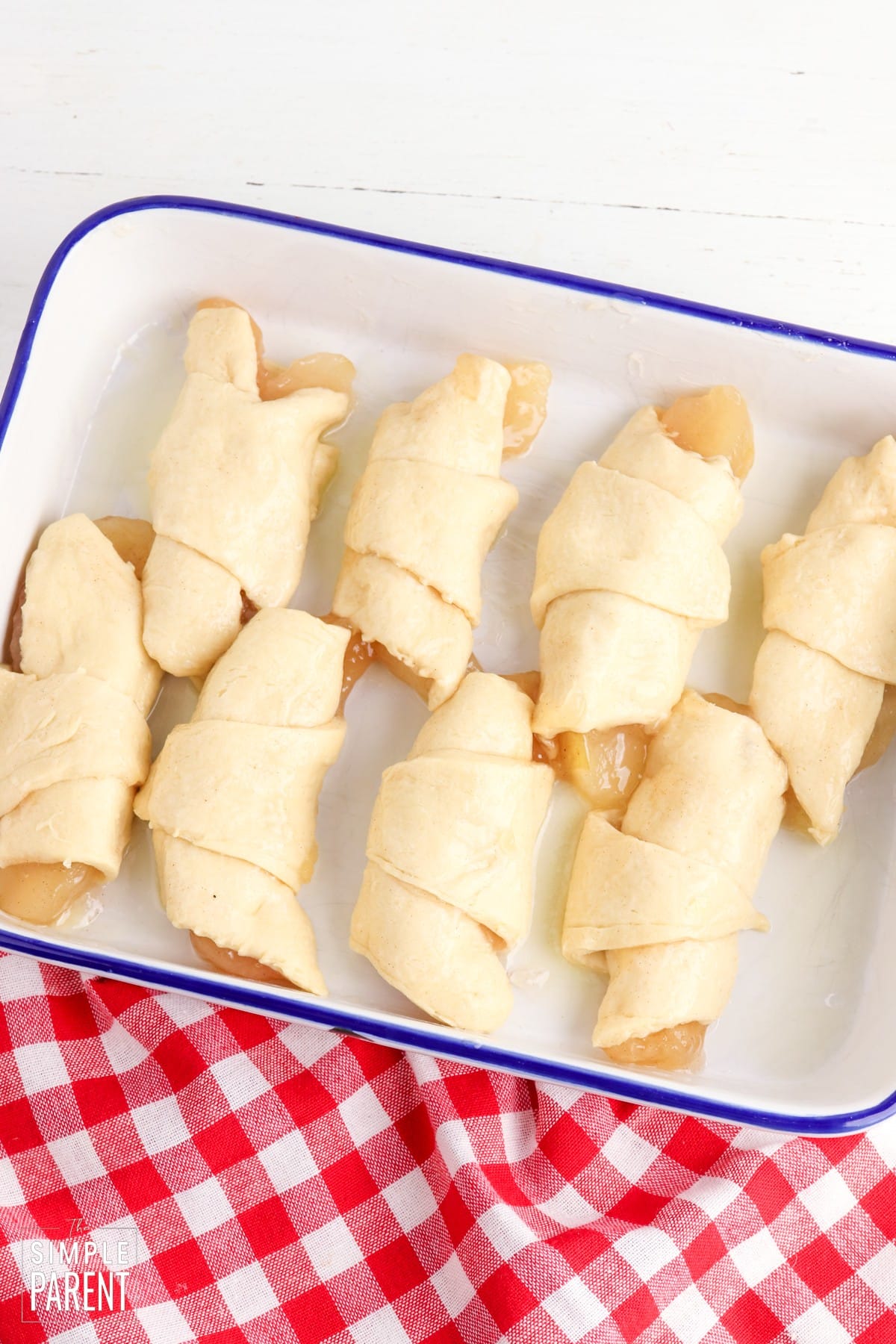 Baking dish with uncooked apple turnovers