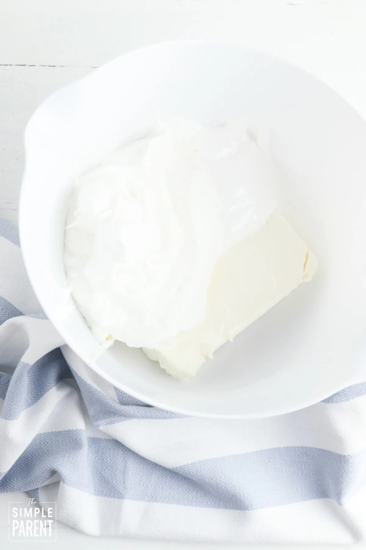 Cream cheese in white mixing bowl
