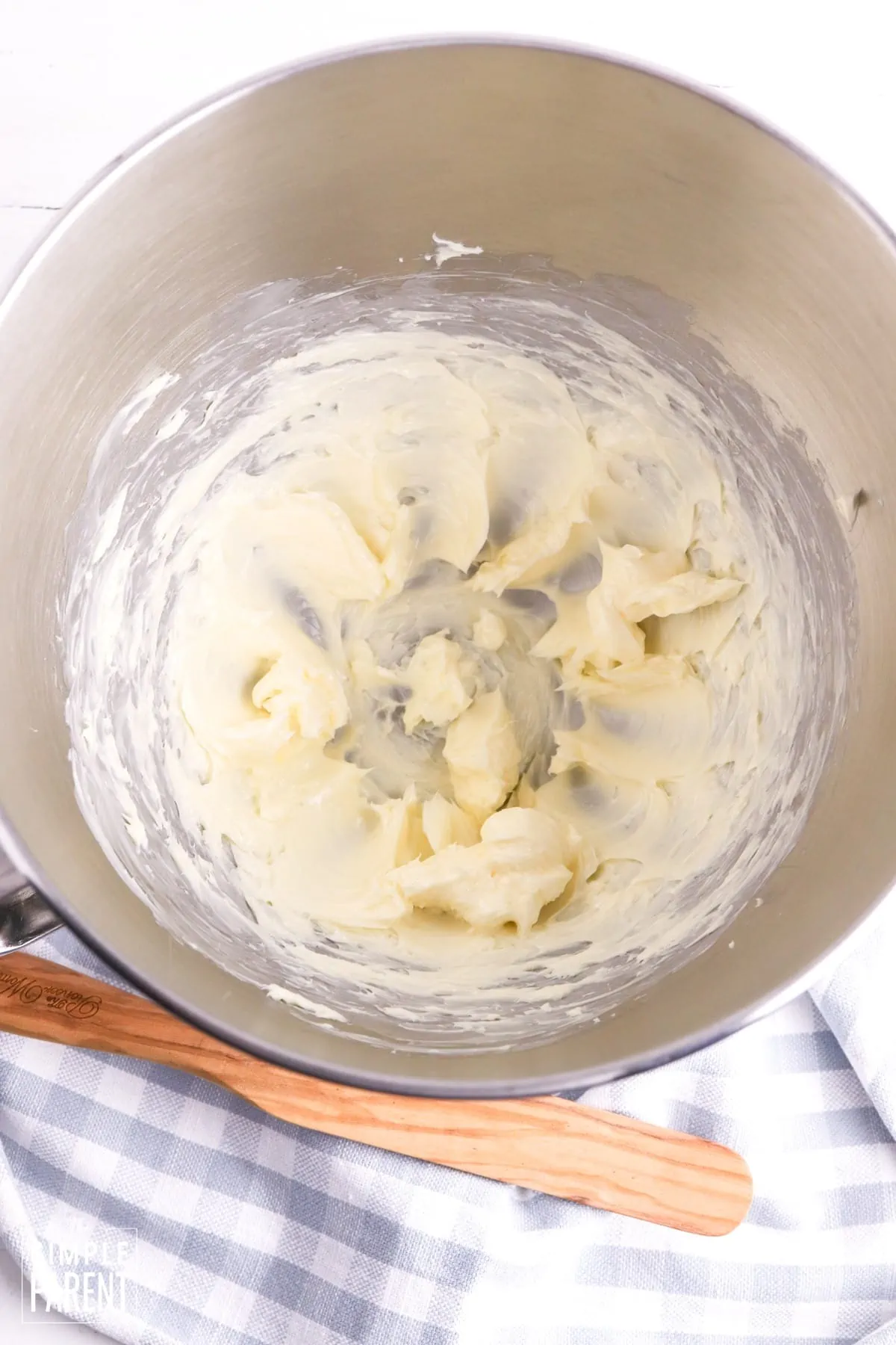Beaten butter in mixing bowl