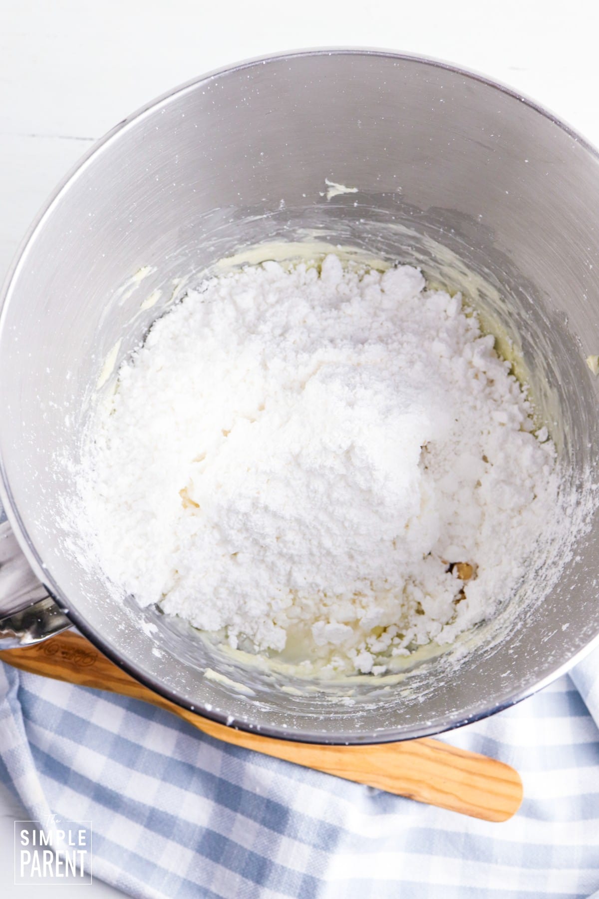 Powdered sugar and butter in mixing bowl