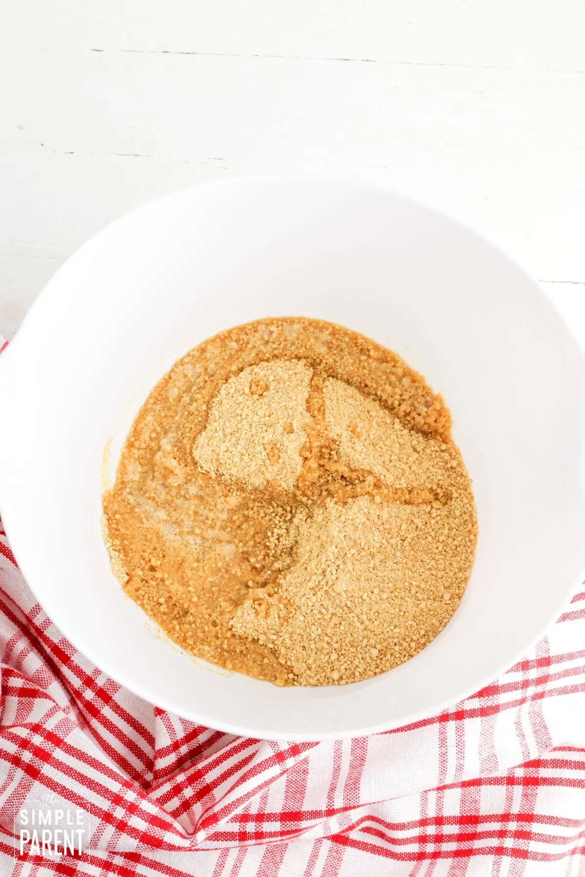 Graham cracker crumbs and melted butter in mixing bowl