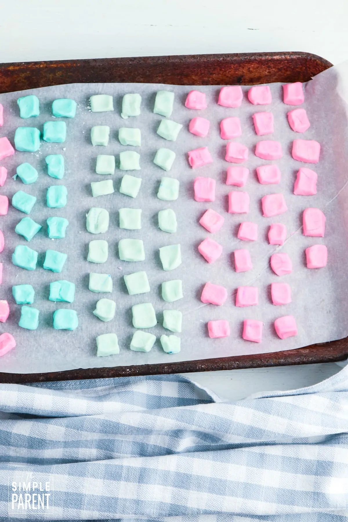Colored butter mints drying on cookie sheet