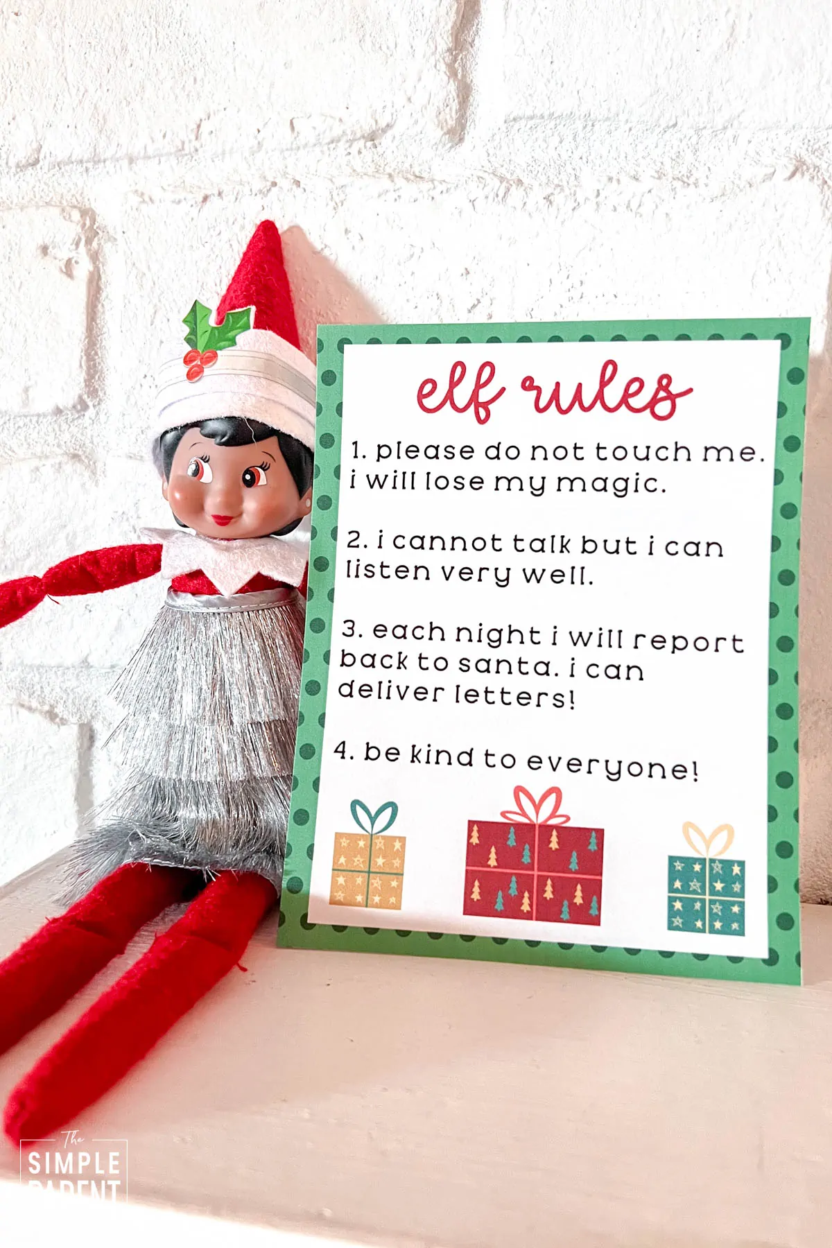 Elf sitting on mantle with Elf on the Shelf rules sheet