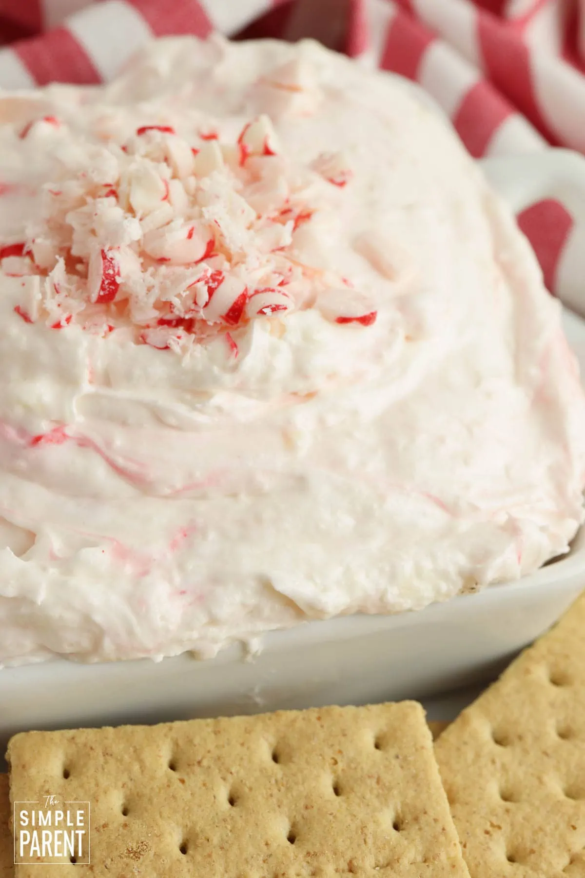 Peppermint Cheesecake Dip in white bowl with crushed peppermint pieces on top