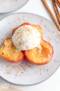 Air Fryer Peaches on white plate with scoop of vanilla ice cream