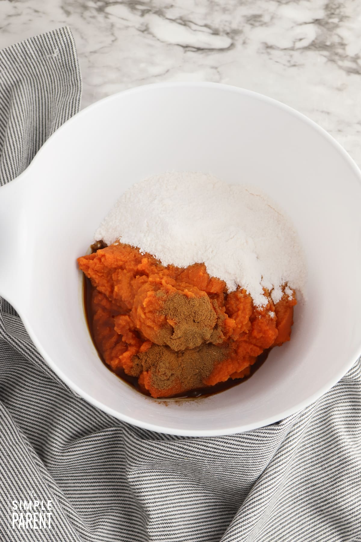 Pumpkin fluff ingredients in white mixing bowl