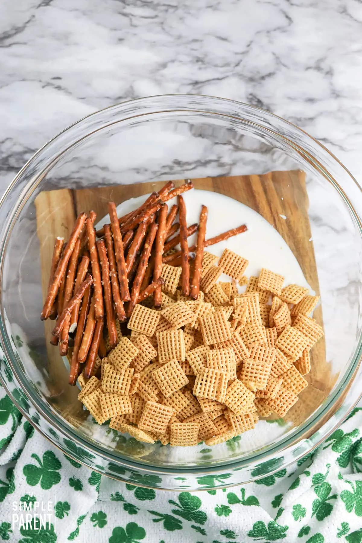 St Patrick's day Chex mix in clear mixing bowl