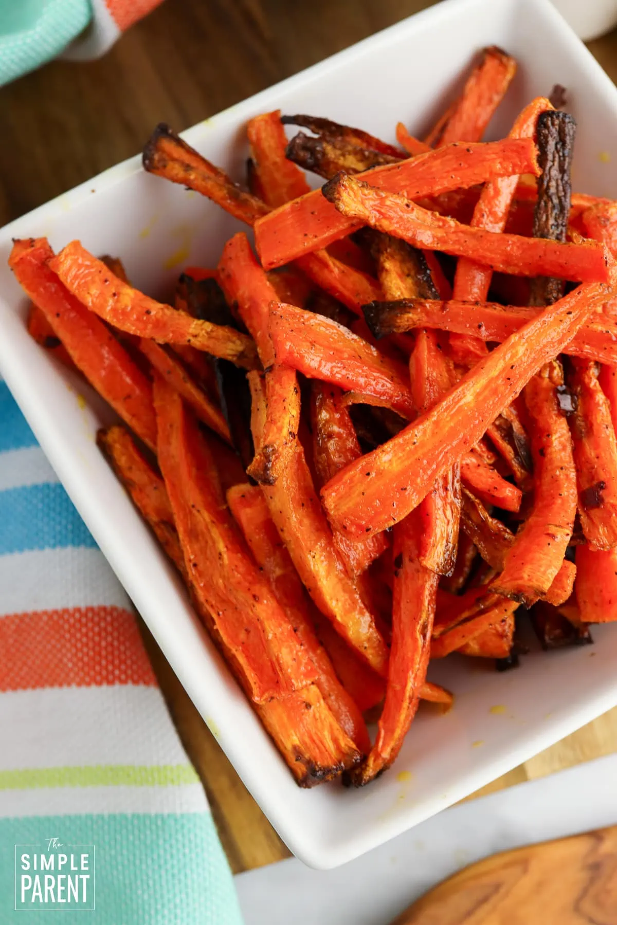 Air fried carrot sticks in a white bowl