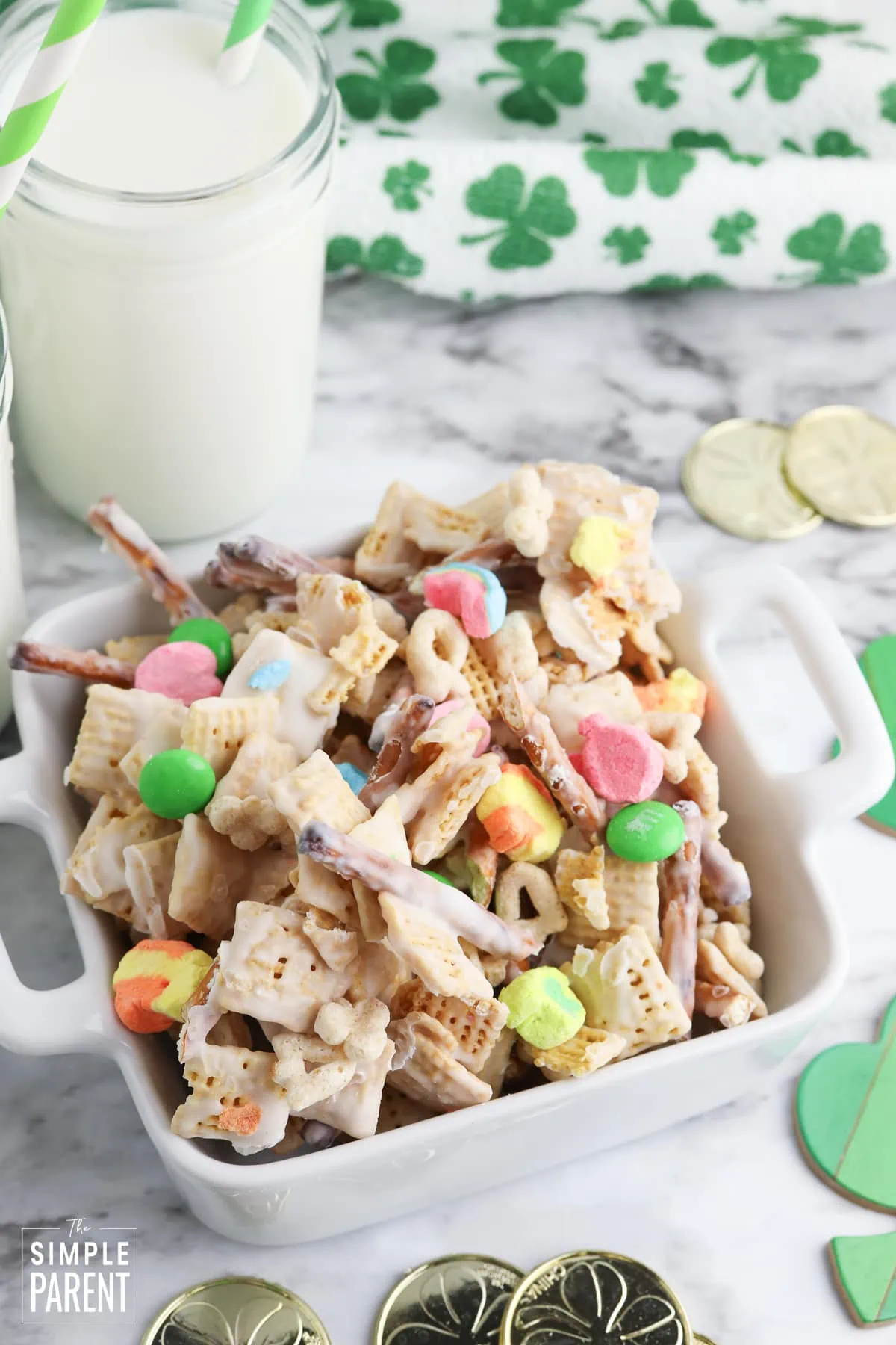 Leprechaun snacks mix in white serving bowl with glass of milk
