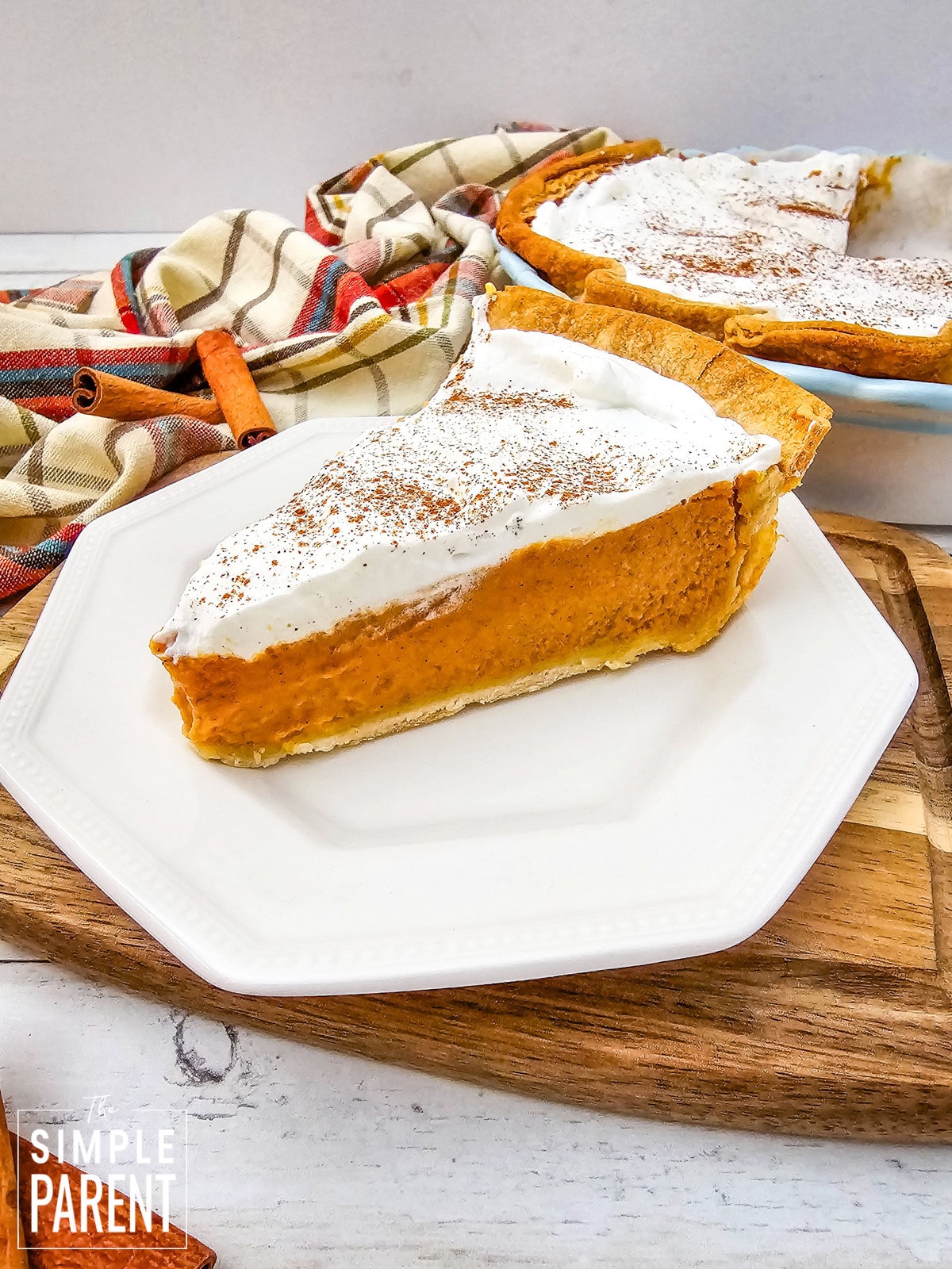 Slice of pumpkin custard pie on white plate