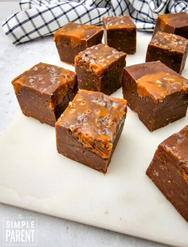Pieces of Chocolate Caramel Fudge on white cutting board