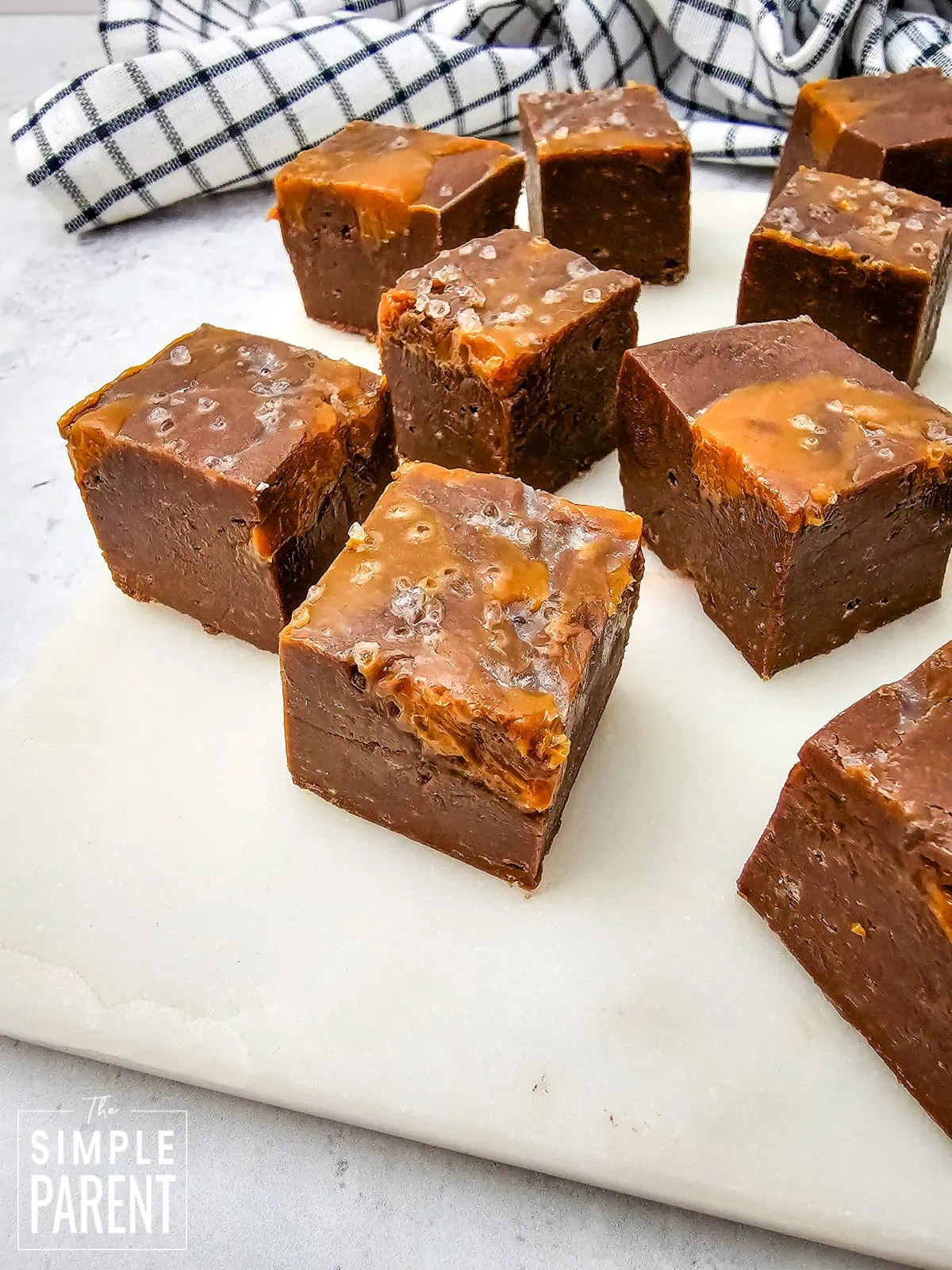Pieces of Chocolate Caramel Fudge on white cutting board