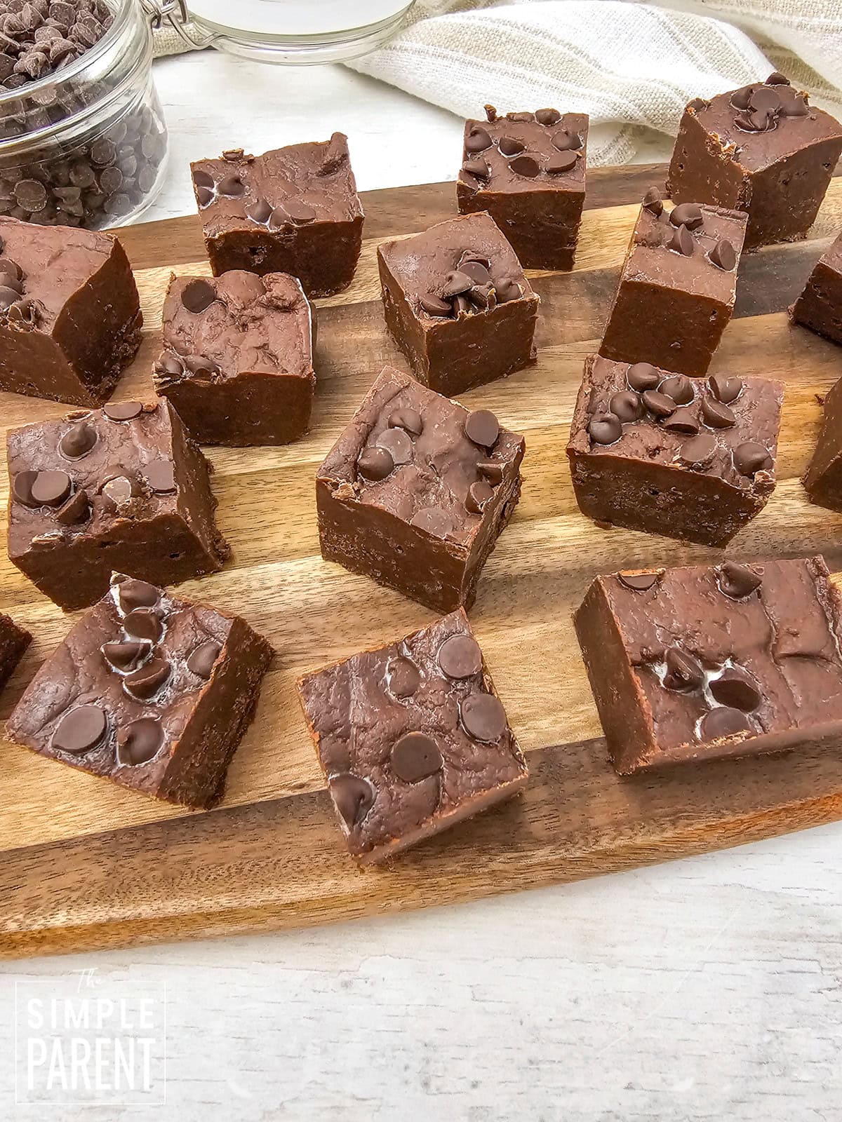 Chocolate condensed milk fudge pieces on wooden plate