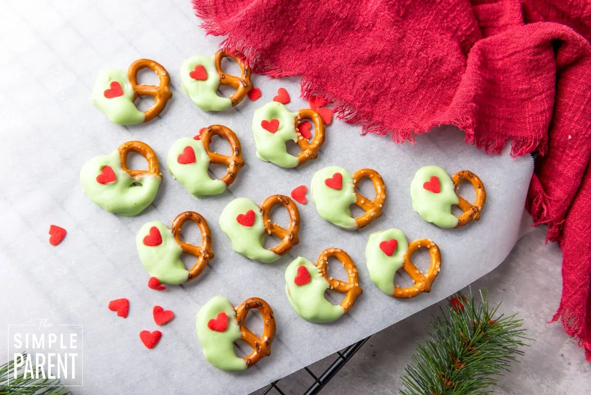 Christmas pretzels dipped in green chocolate on gray counter