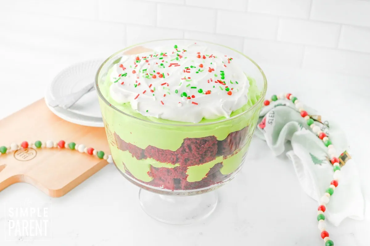 Red and Green Christmas Trifle dessert in glass bowl on white counter
