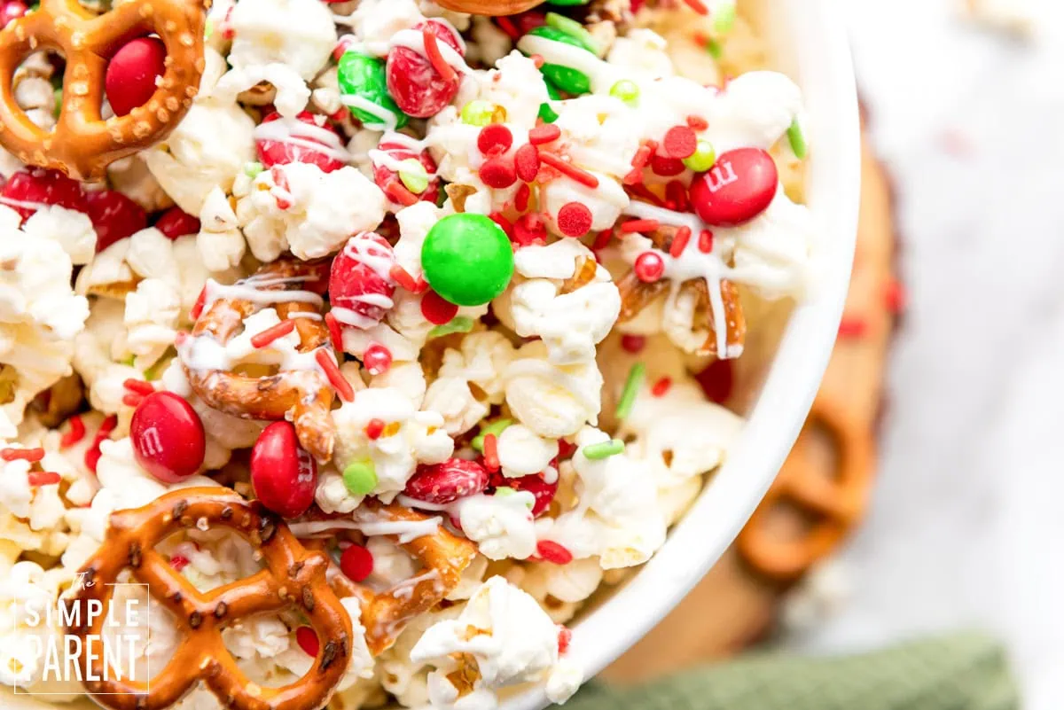 Christmas white chocolate popcorn snack mix in a white bowl